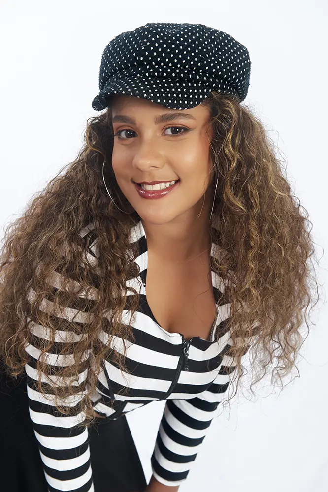 Plano americano de joven morena con pelo rizado y blusa a rayas blanco y negro